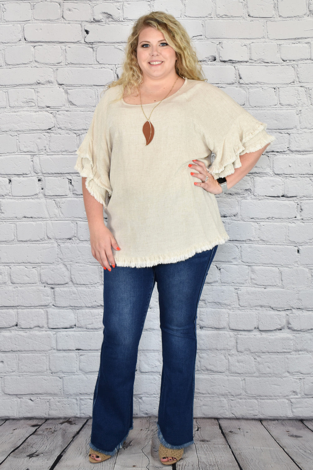 https://hometownheritageclothing.com/cdn/shop/products/Double-Ruffle-Sleeve-Linen-Tunic-Top-with-Frayed-Hem-in-Plus-Size-by-Umgee-Clothing-9_1400x.jpg?v=1674854922